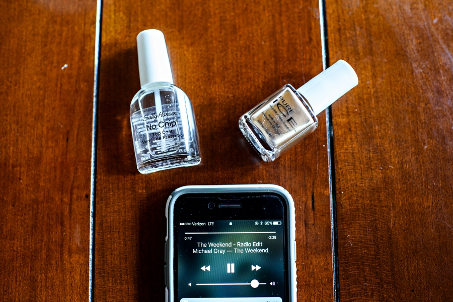 Music playing on the iphone while makeup is being done for the brides.